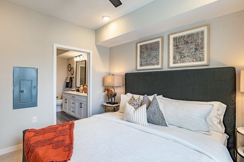 a bedroom with a large bed and a bathroom