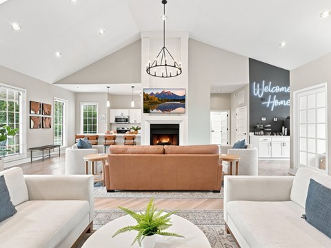 A living room with a large couch and a fireplace.