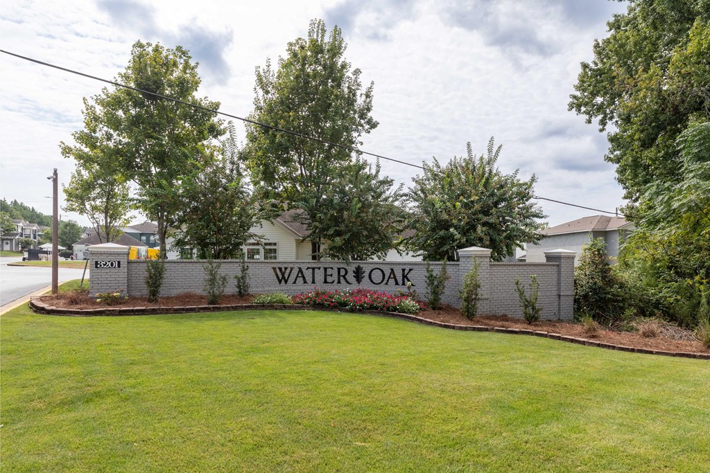 A sign that says "Watersoak" is in front of a grassy area.