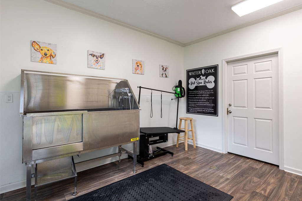 A room with a water oak sign on the door and a metal table.