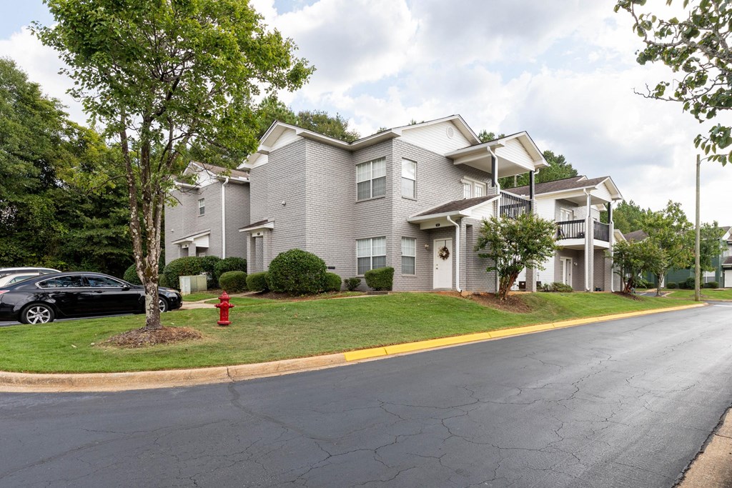 A black car is parked on the side of a street.