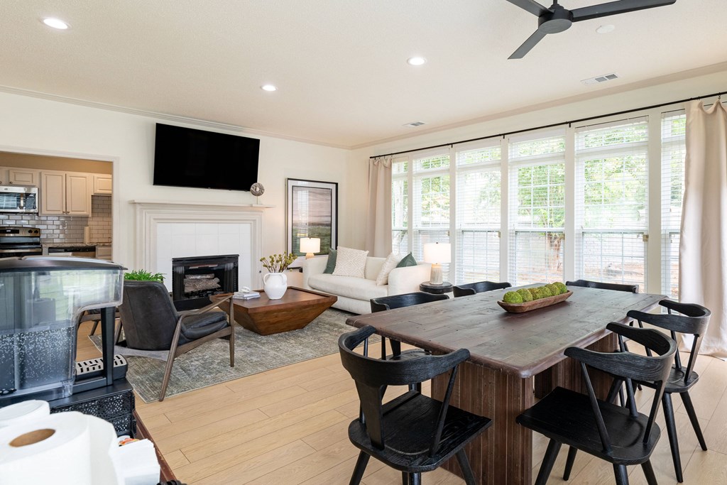 a living room with a table and chairs and a fireplace