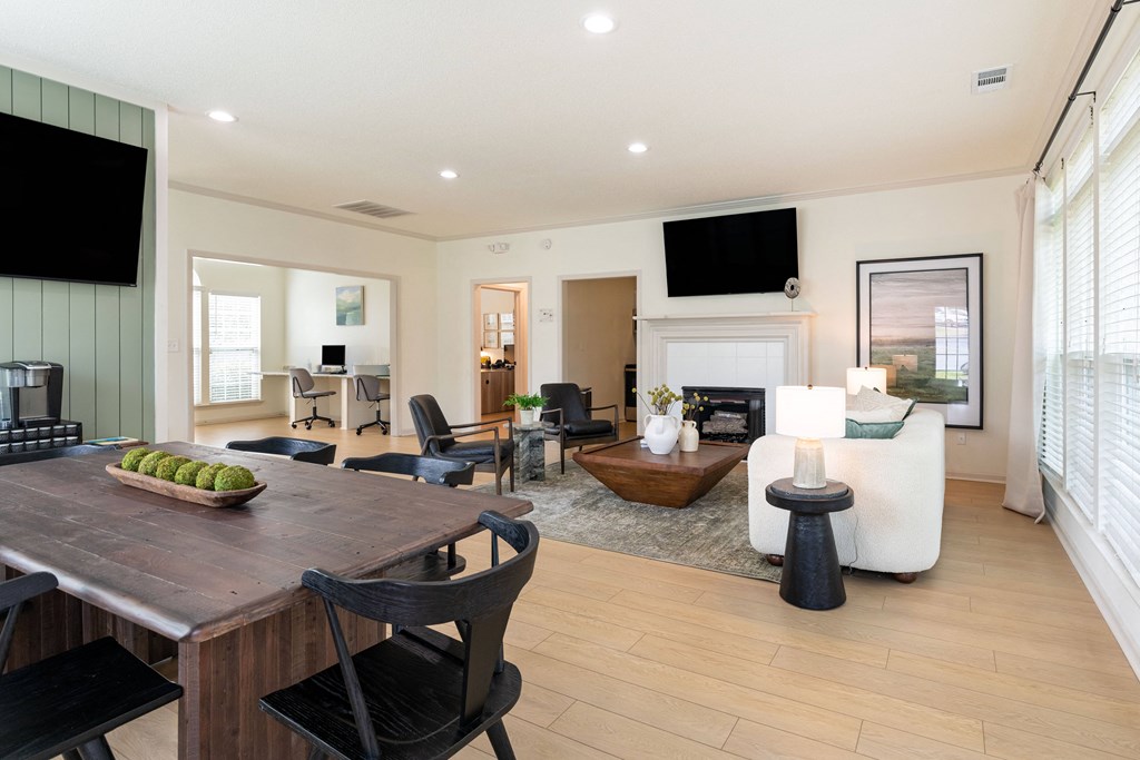 a living room with a fireplace and a dining table