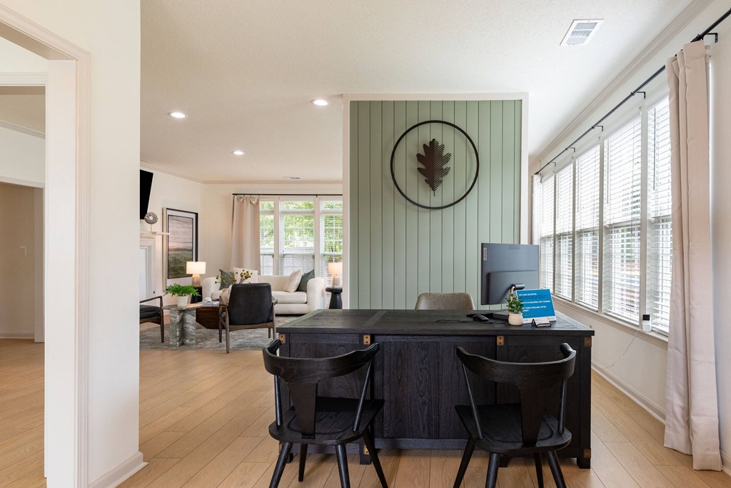 a home office with a desk and chairs