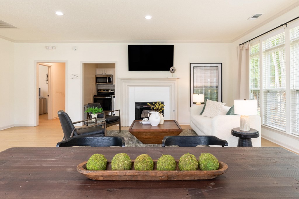 a living room with a table with a bowl of fruit on it