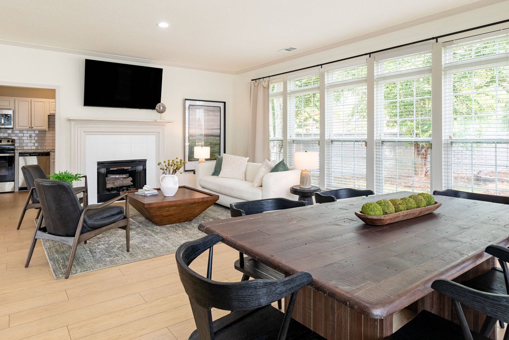 a living room with a table and chairs and a fireplace