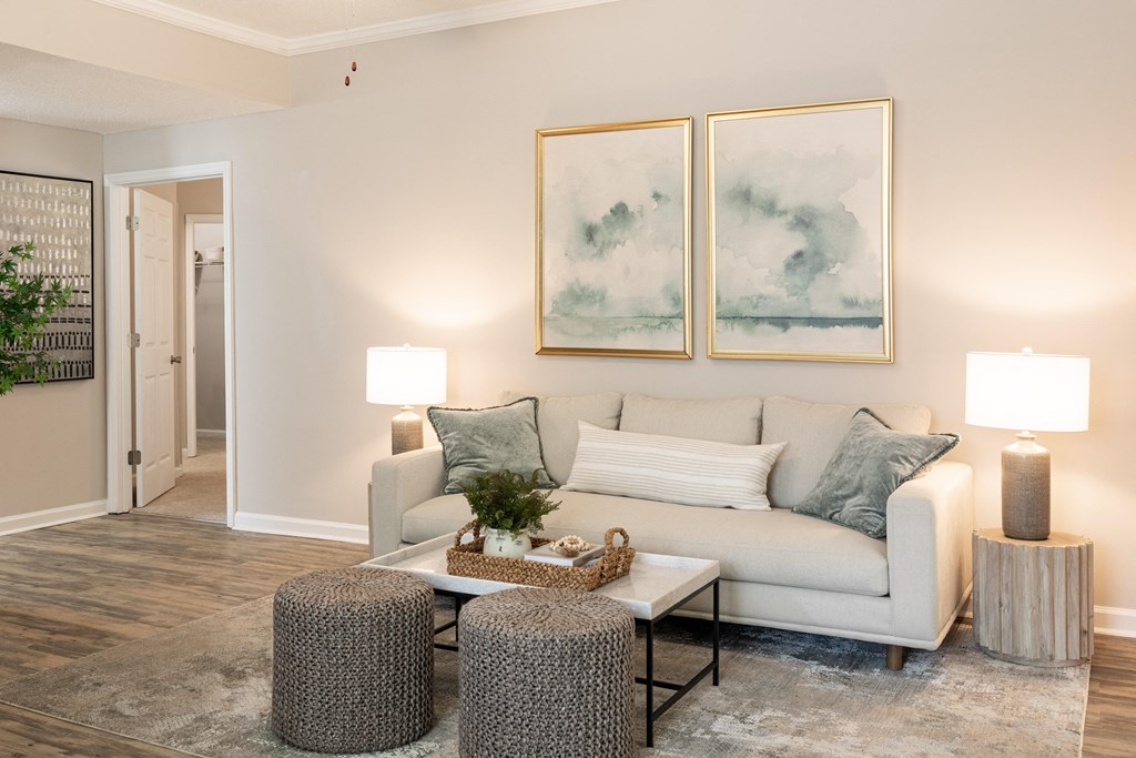 a living room with a couch and two paintings on the wall