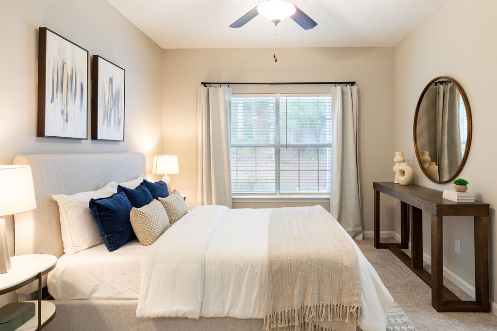 a bedroom with a large bed and a window