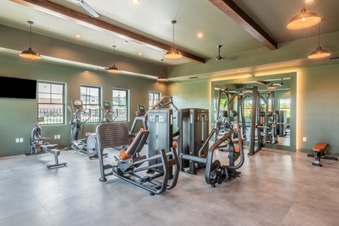 a gym with cardio machines and other exercise equipment