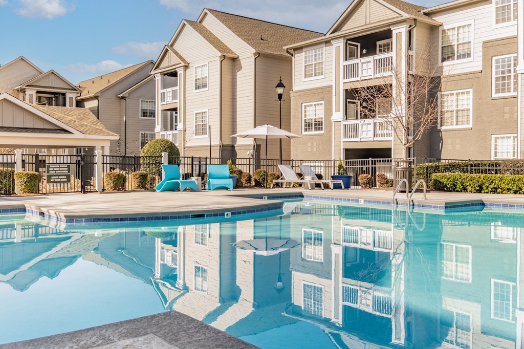 our apartments have a swimming pool with chairs and umbrellas