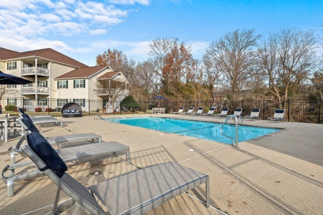 a swimming pool with chairs around it
