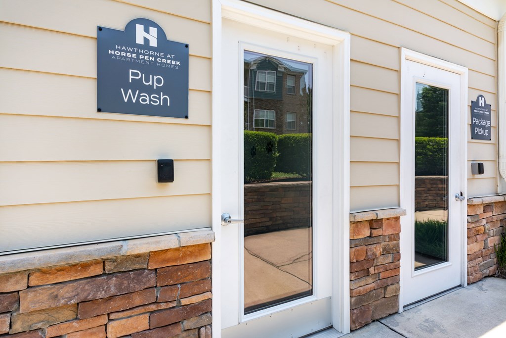 A sign on a building that says Pup Wash.