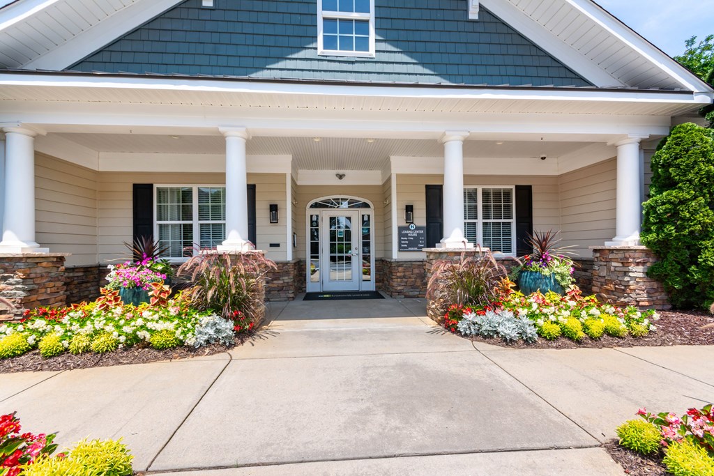 A house with a white front porch and a white door.