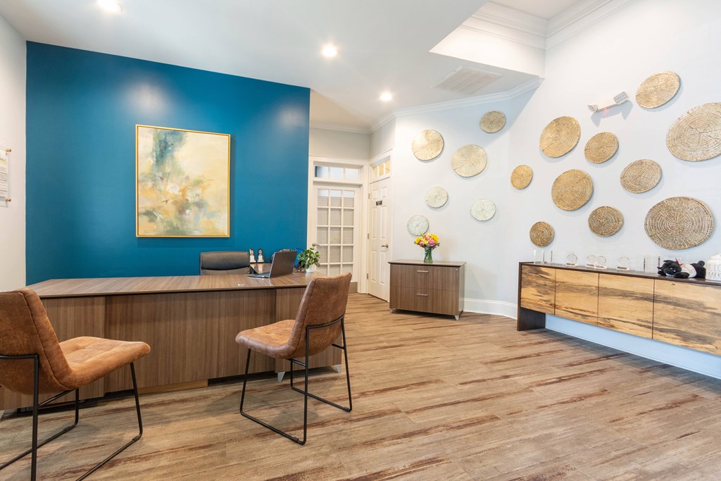A reception area with a blue wall and a painting.