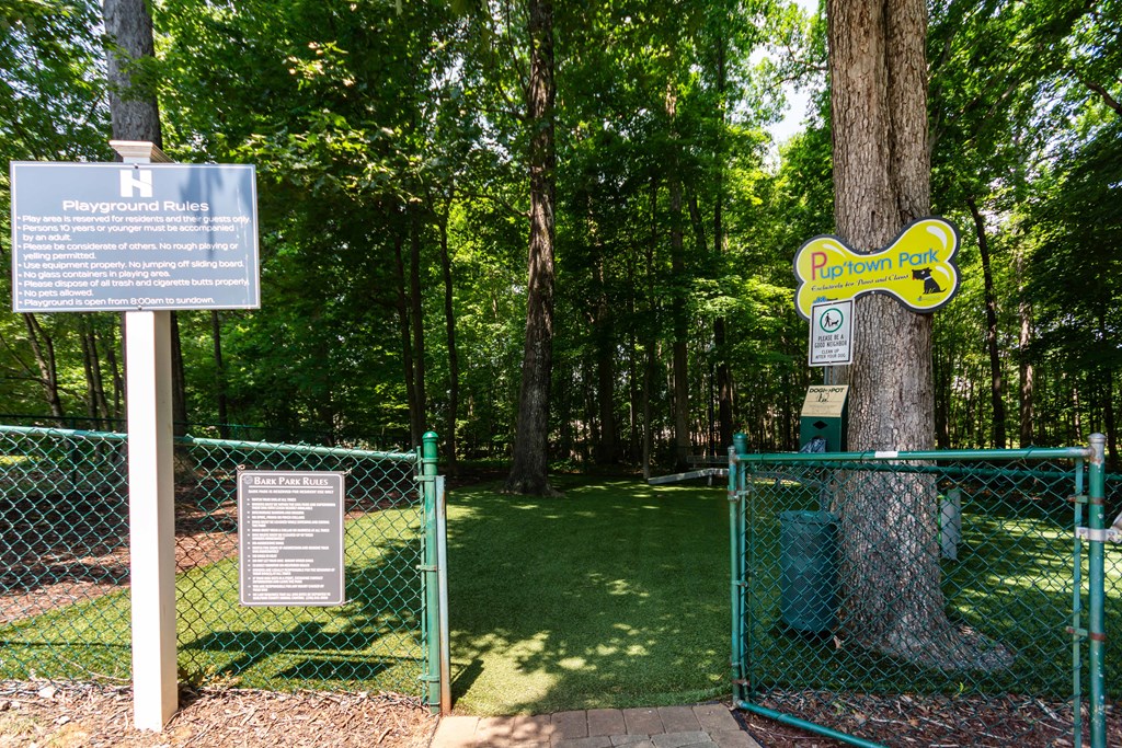 A sign in a park that says Playground Rules.