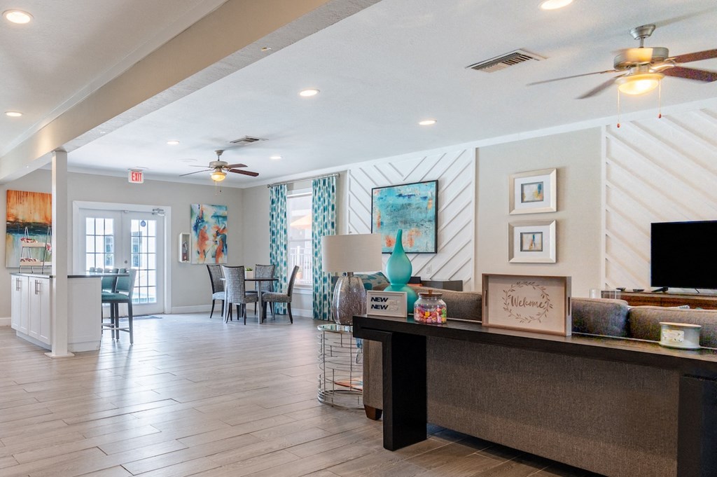a resident clubhouse with a reception desk and dining room in the background