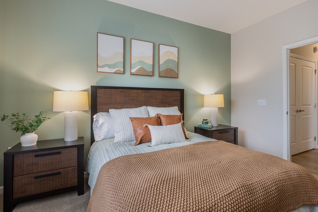 a bedroom with a large bed and two night stands with lamps