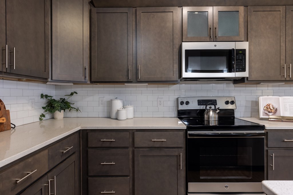 Home Interior a kitchen with black appliances and brown cabinets