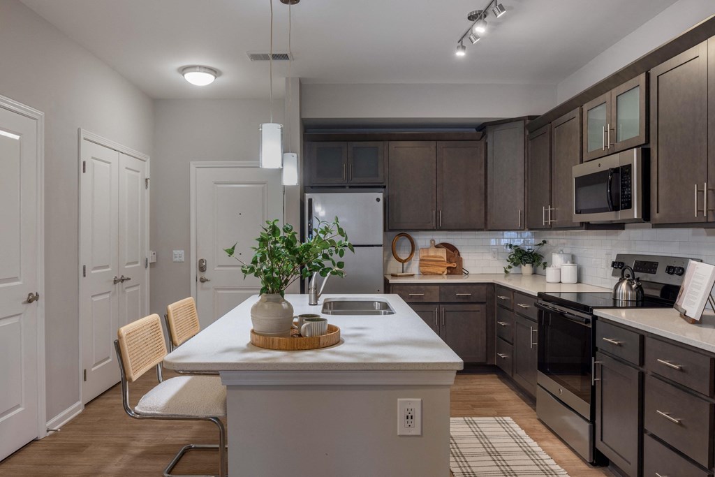 an open kitchen with a large island with a white counter top