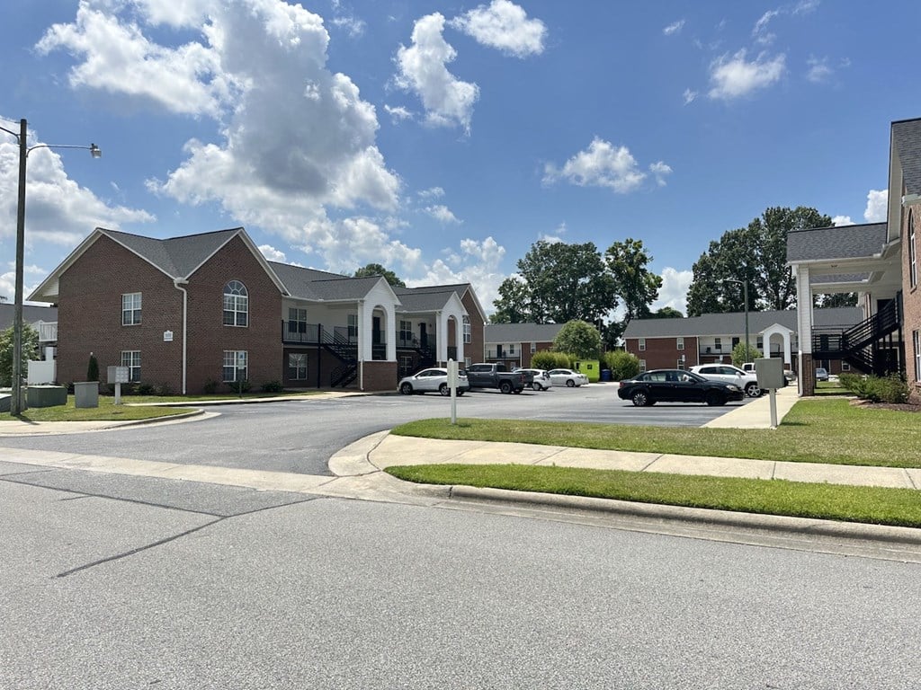 a street in a neighborhood with houses and cars on it