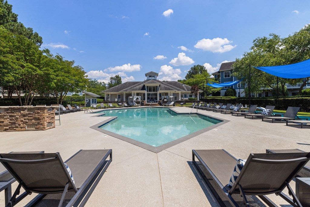 the resort style pool is surrounded by lounge chairs and umbrellas