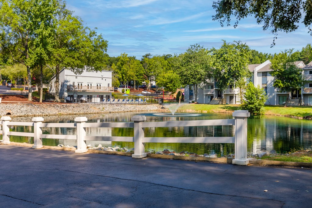 a bridge over a lake with houses in the background