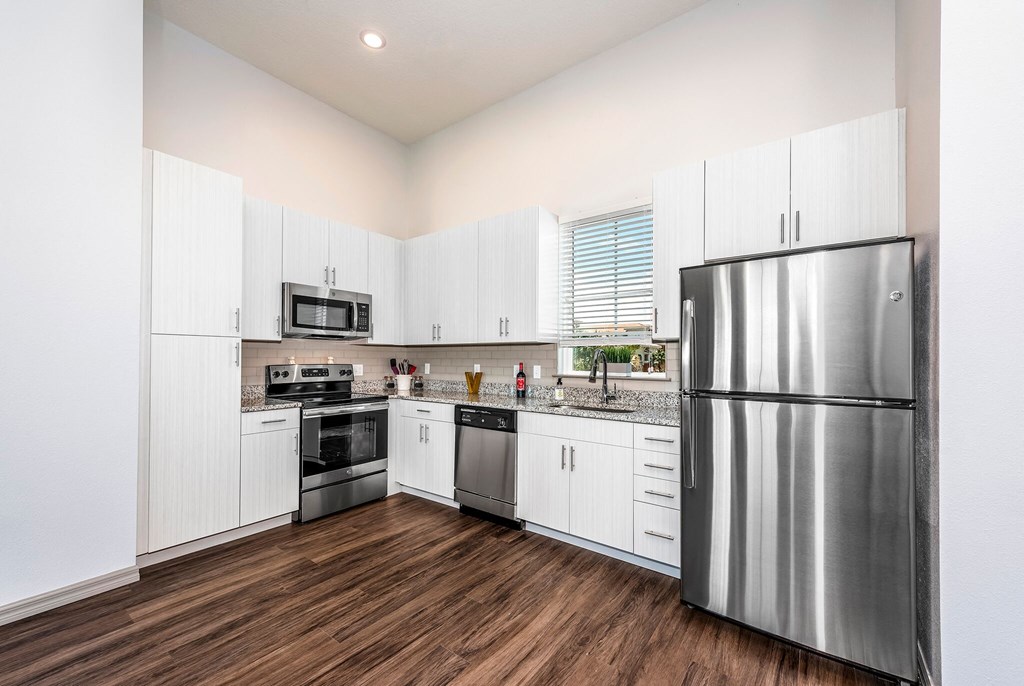 a kitchen with stainless steel appliances and white cabinets