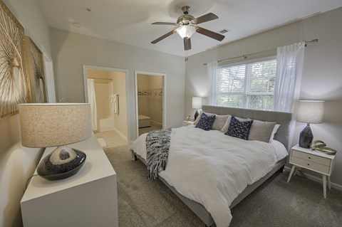 a bedroom with a bed and a ceiling fan