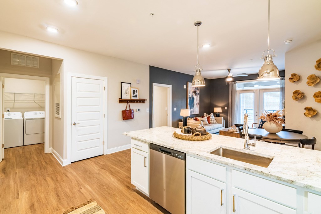 a kitchen with white cabinets and a sink and a counter top