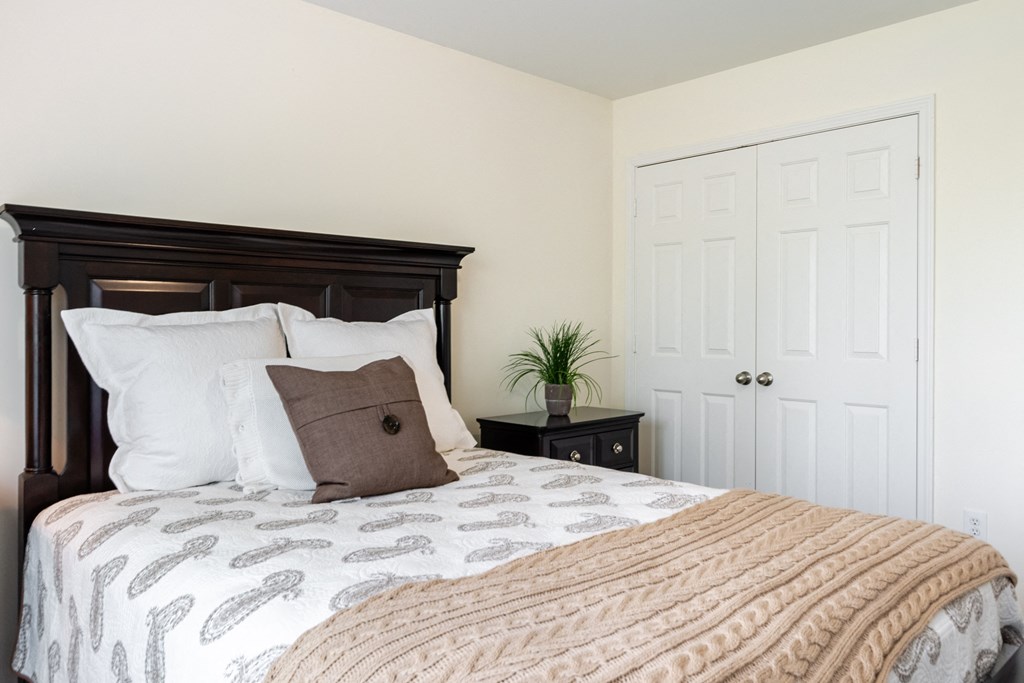 a bedroom with a large bed and a white door
