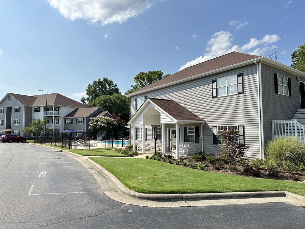 a house on the corner of a street with other houses