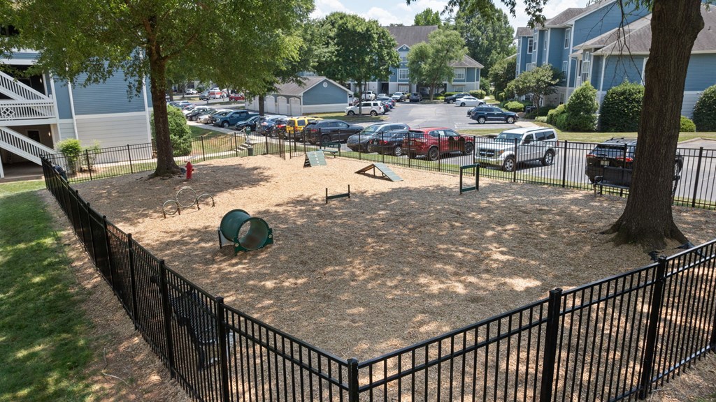 a playground in a fenced in area in a residential neighborhood