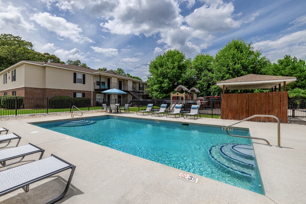 the preserve at ballantyne commons resort style swimming pool with chairs and trees
