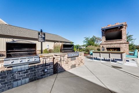 the preserve at ballantyne commons outdoor patio with grills and a tv
