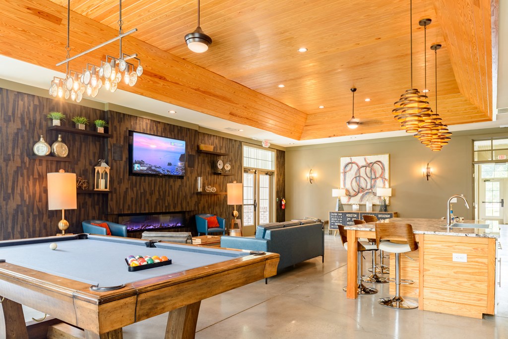 a game room with a pool table and a tv
