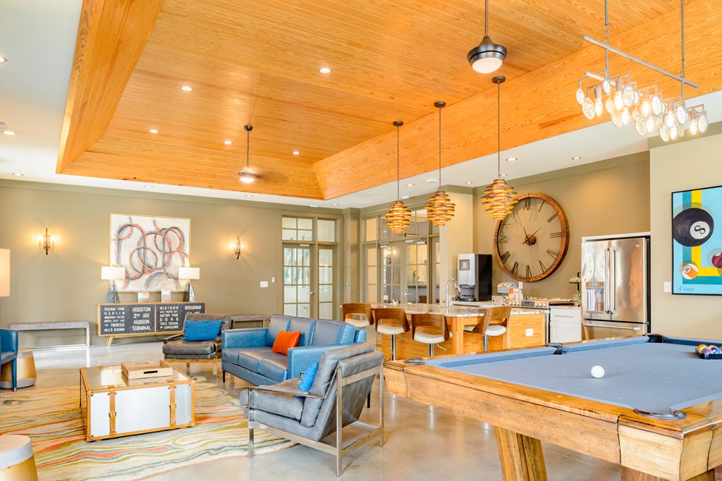 a game room with a pool table and a large clock