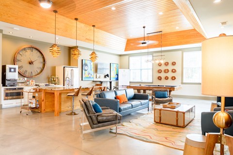 a living room with furniture and a large clock on the wall