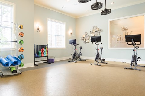 a fitness room with exercise equipment at the community center