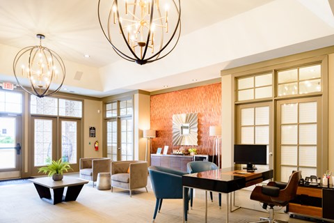 the lobby of a hotel with a living room and a dining room