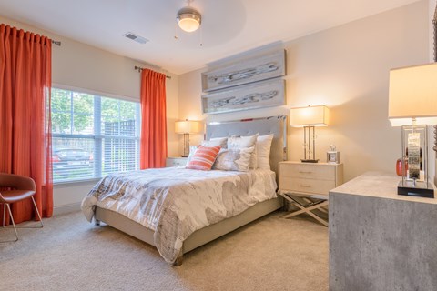 a bedroom with a bed and two windows