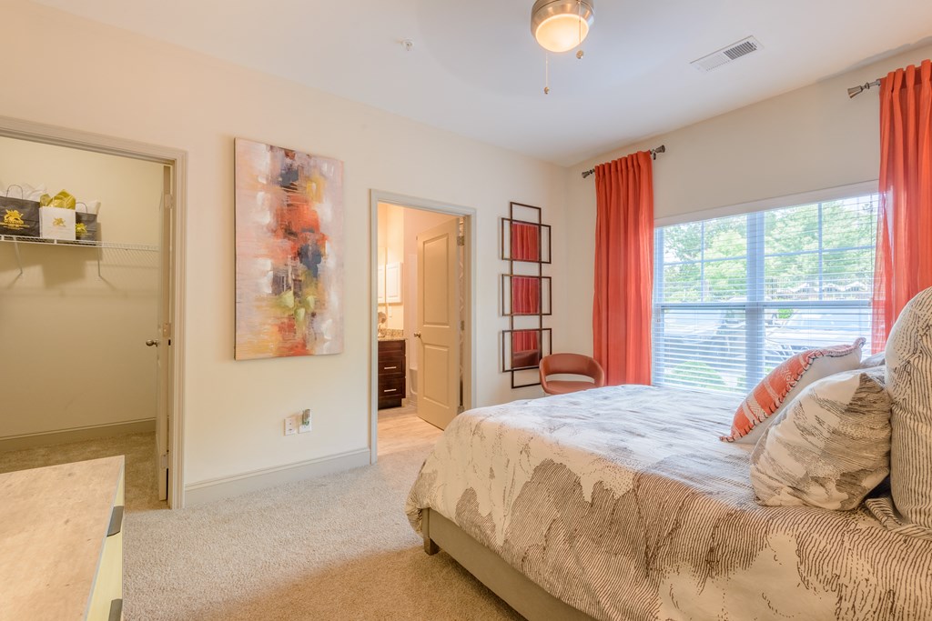 a bedroom with a bed and a door to a bathroom