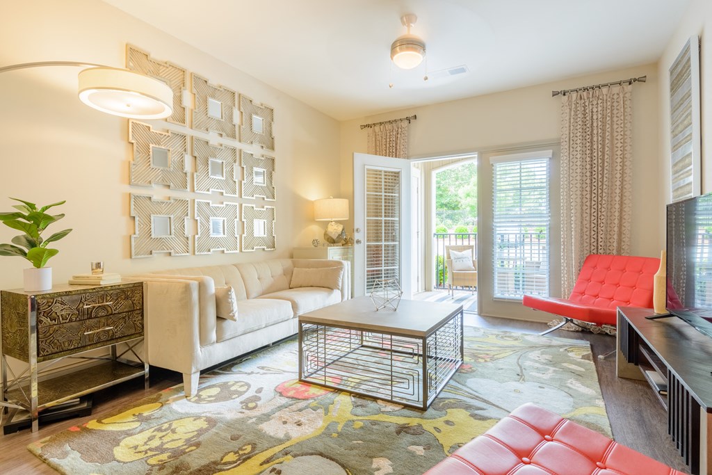 a living room with a couch and a coffee table    and a door