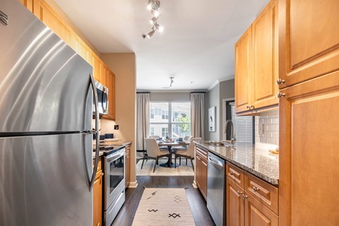 a kitchen with stainless steel appliances and wooden cabinets