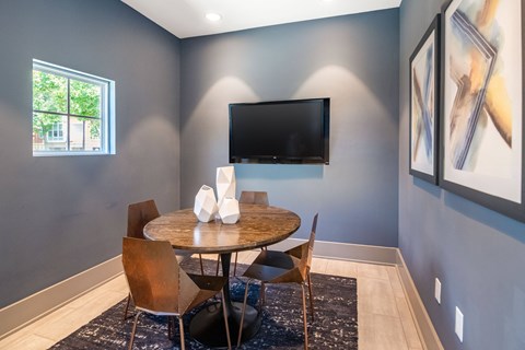 a dining room with a table and chairs and a television