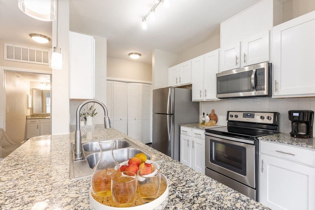 a view of a kitchen with a counter and a bowl of fruit