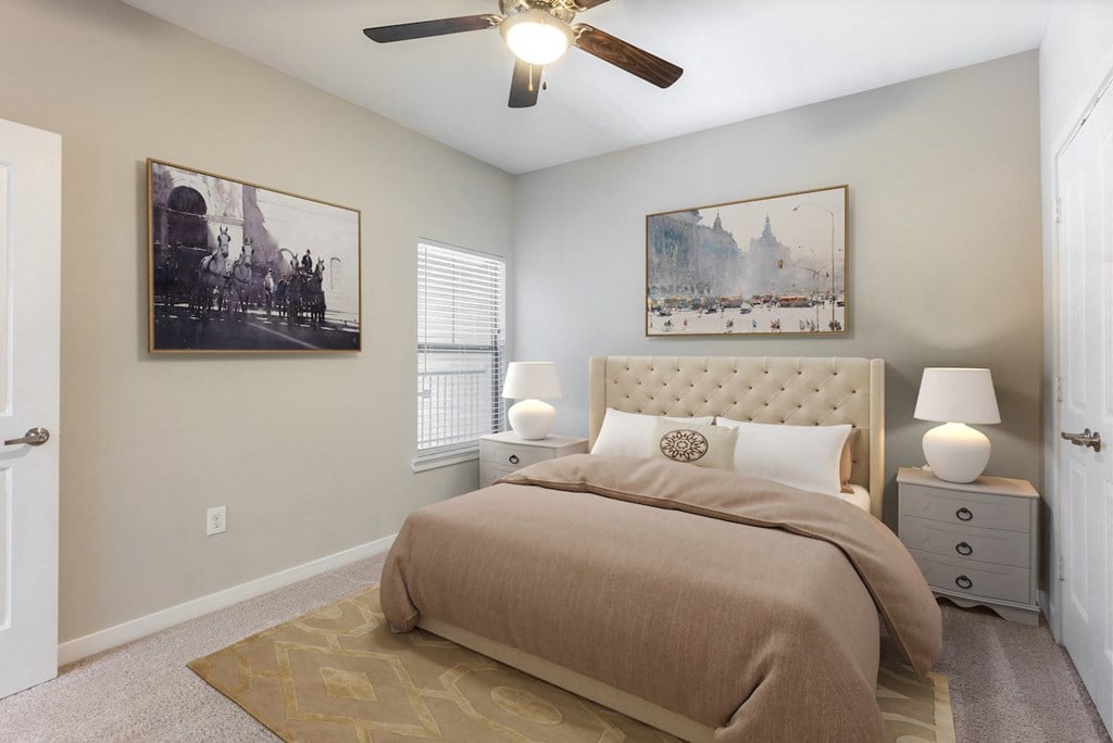 a bedroom with a bed and a ceiling fan