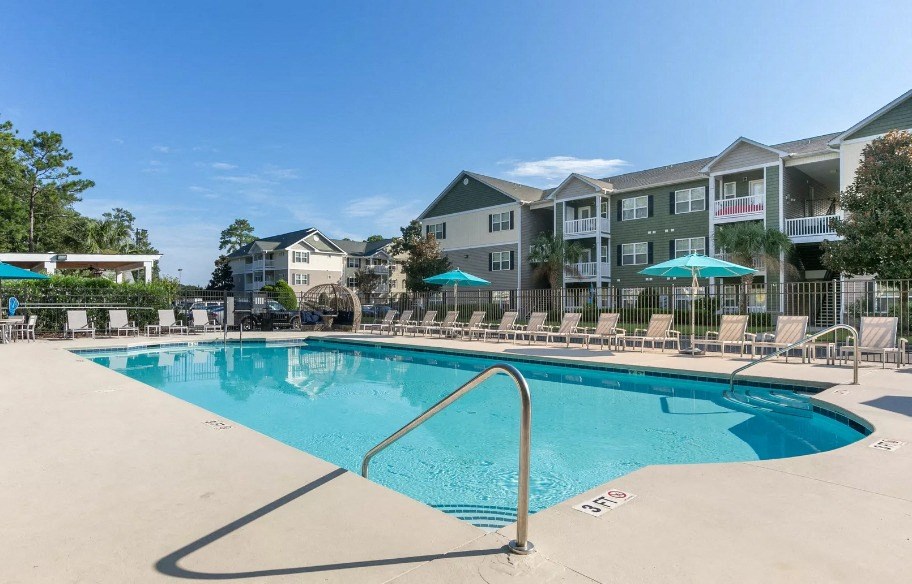 our apartments offer a swimming pool with an apartment building in the background