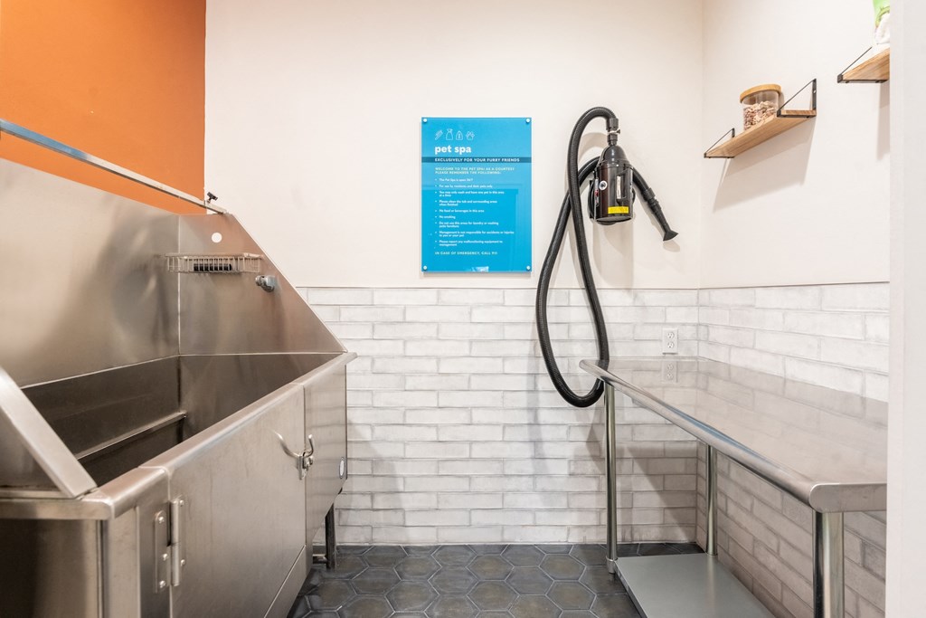 a kitchen with stainless steel appliances and a gas hose