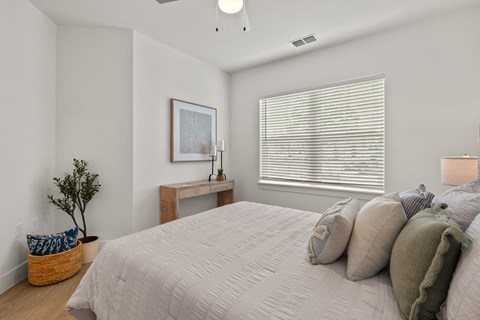 a bedroom with a large bed and a window