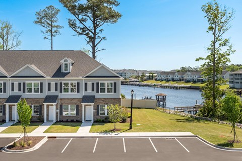 a large house with a body of water in the background
